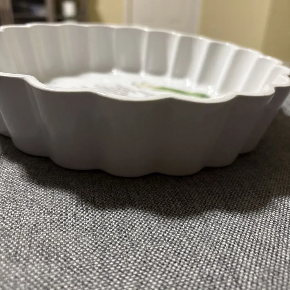 This is a vintage white ceramic quiche or flan baking dish